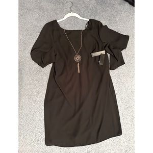 Black mini dress with gold necklace